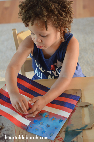 Fun American Flag Kids Craft! Make this beautiful watercolor with your children for memorial day, the 4th of July or to cheer on Team USA at the olympics. This DIY watercolor is beautiful and easy to make with kids.