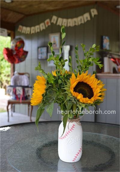 Cute birthday party decor. Paint a mason jar with chalk paint and add baseball stitches. Great for a boy's ball or sports theme party.