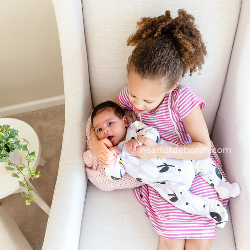 Give the older kids jobs to encourage a bond between new siblings. My daughter loves to sing patty cake to her new baby sister.